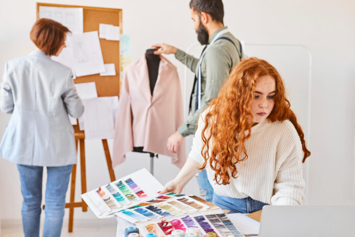 group-fashion-designer-working-atelier-with-color-palette-dress-form Fashion Production