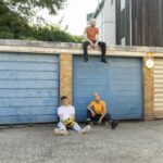 long shot friends sitting outdoors