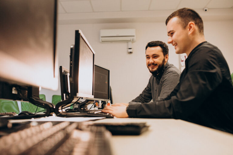 young male web designers working computer